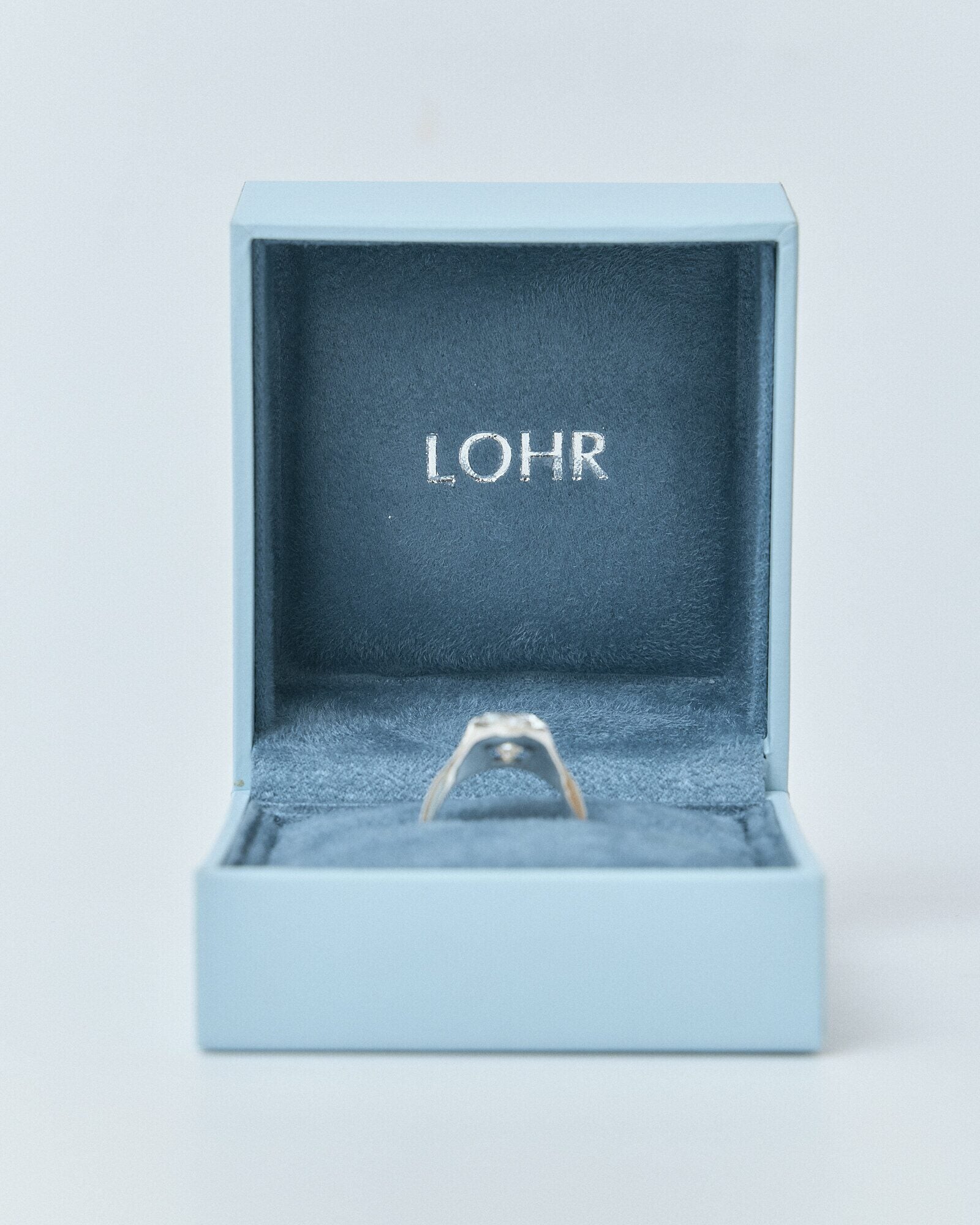 A LOHR ring resting inside its case